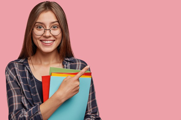 studio-shot-good-looking-young-businesswoman-posing-against-pink-wall-with-glasses_273609-20864